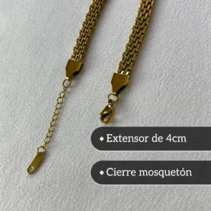 Cierre de Seguridad y Extensor de Pulsera Detalle del cierre mosquetón y la cadena extensora de la pulsera de acero dorada.