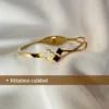 Calidad Superior en Joyas de Acero Detalle de la pulsera esclava dorada con el texto "Máxima calidad".